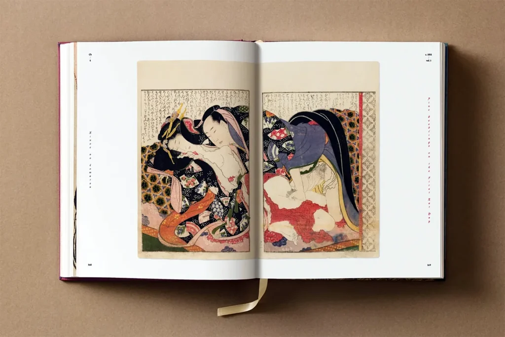 Open Hokusai Shunga art book showing erotic woodblock print of a couple